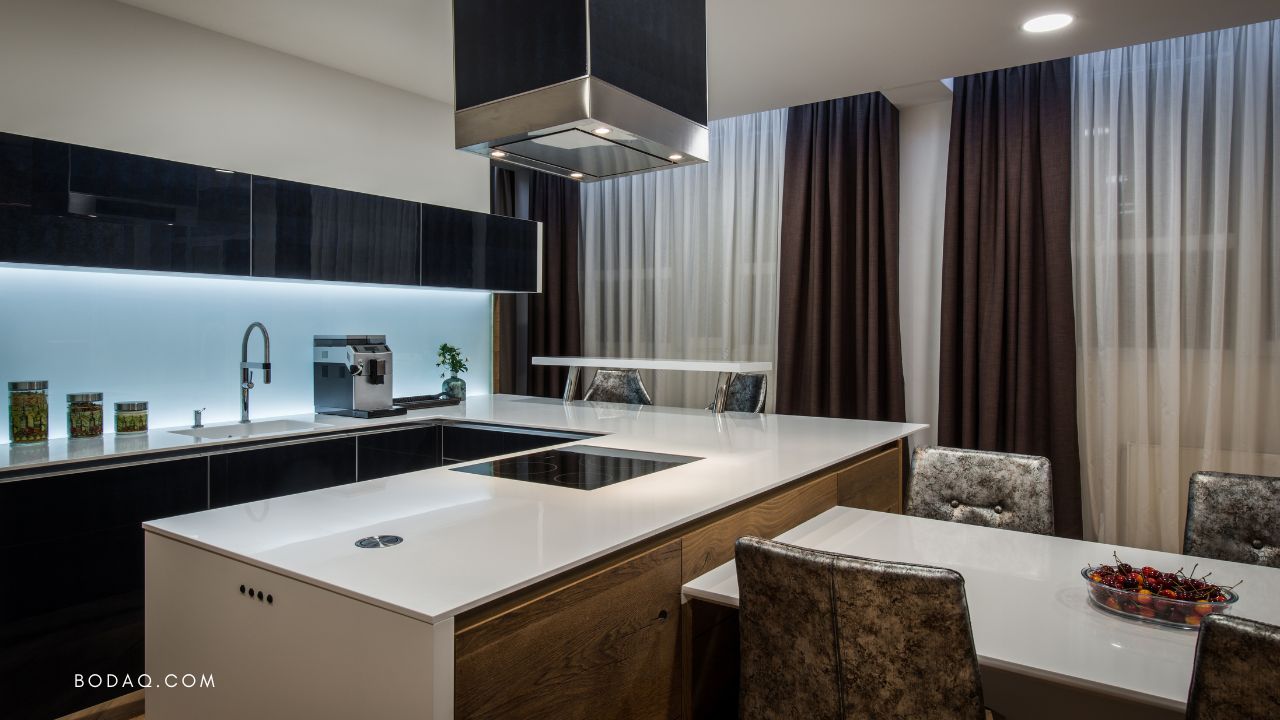 Dark high-gloss kitchen cabinetry with wood island