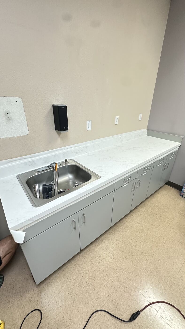 Finished countertop wrapped in Bodaq marble-look film, sink reinstalled
