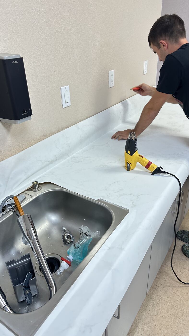 Trimming and heat-forming the film along the countertop edge