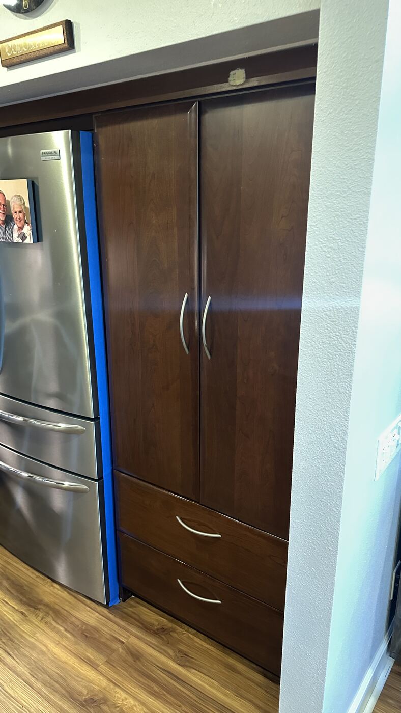 Dated dark wood pantry cabinet before Bodaq film wrap