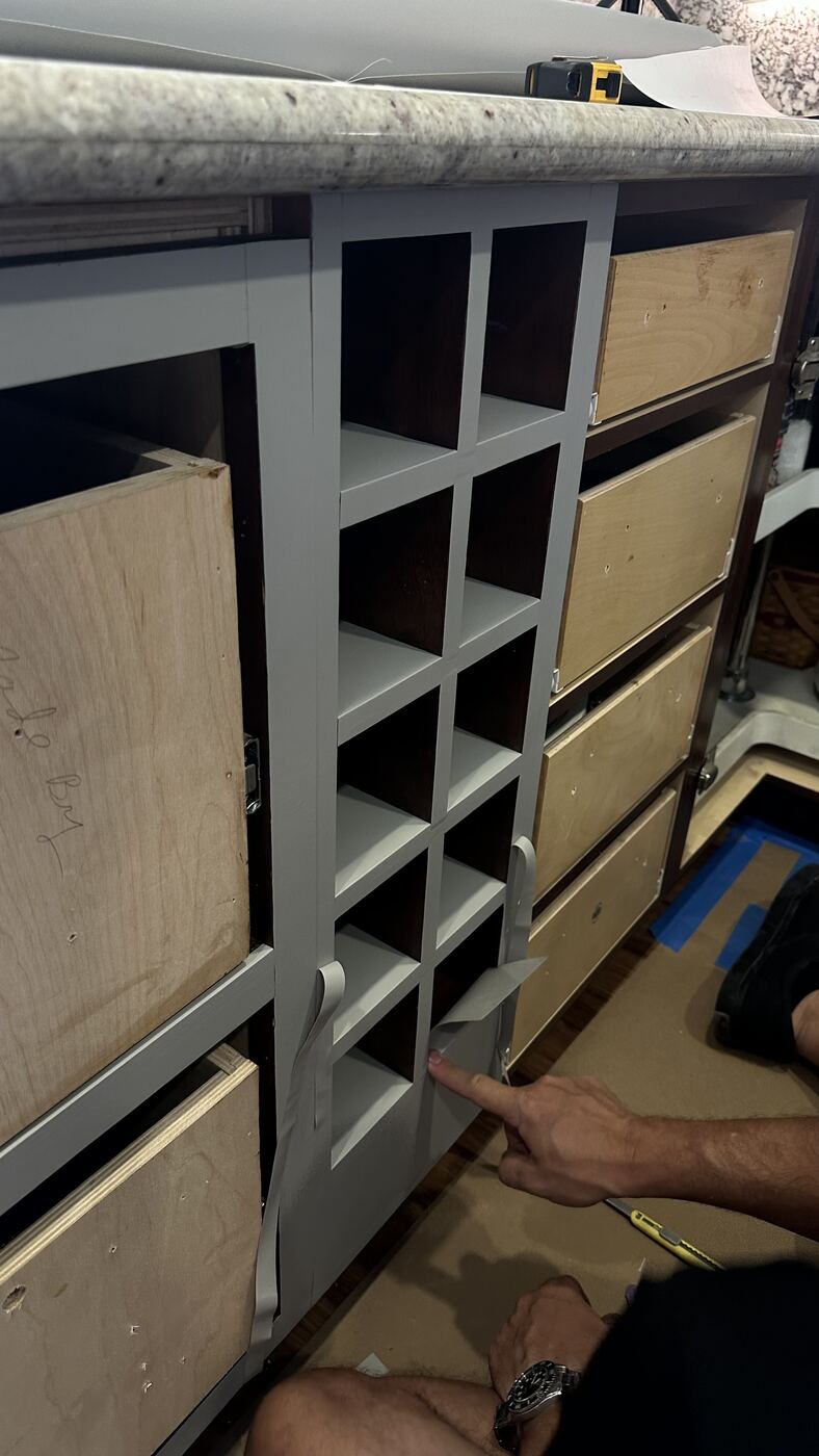 Cabinet boxes mid-install with drawer fronts removed for wrapping